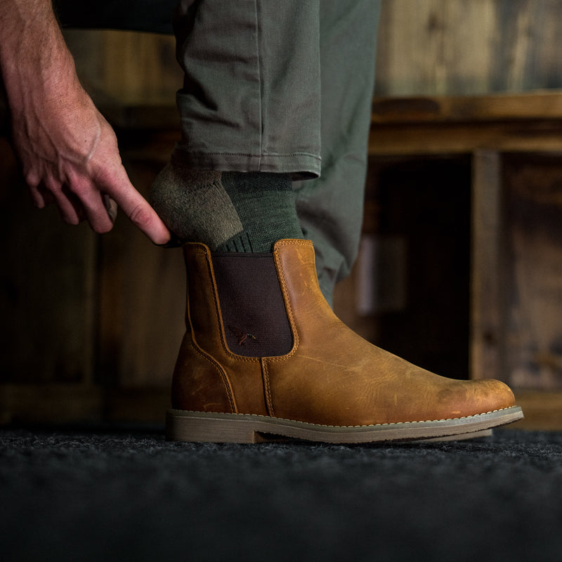 Dive Bomb Tobacco Brown Heritage Boot being slipped on.